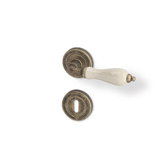 Antik R - matt bronze patina/ porcelain - Door Handle on a Round Rose